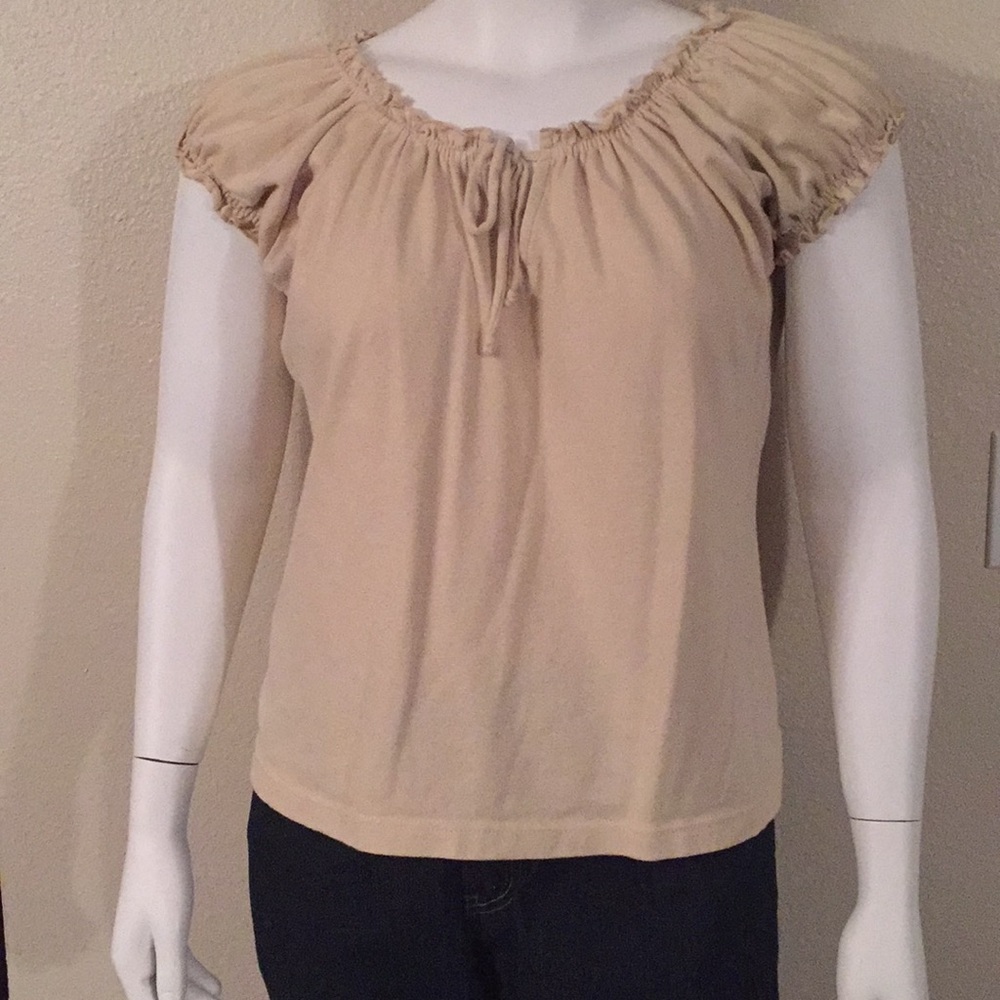 Blouse with ruffled neckline and cap sleeves.
